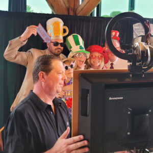 a group of people standing around a television