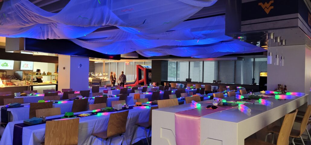 a large room with tables and chairs covered in white cloths