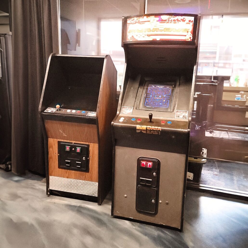 two arcade machines sitting next to each other