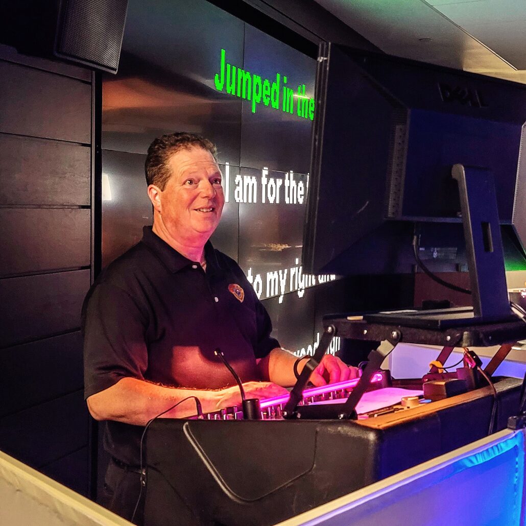 a man standing at a podium in front of a computer